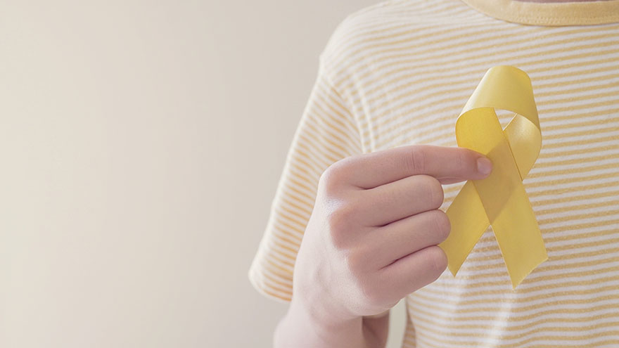 Hands holding yellow gold ribbon