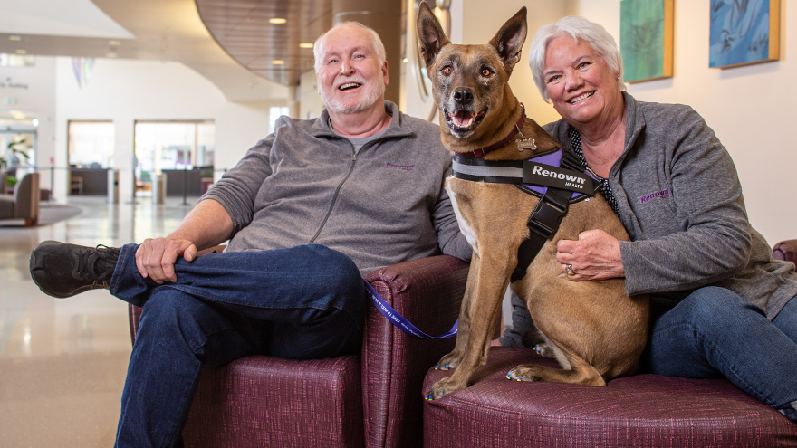 Richard and Vickie Lange sitting with their therapy dog, Raven. 